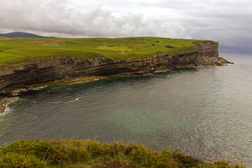 cliff with storm in the background