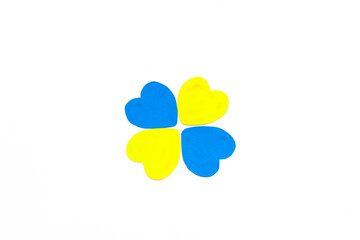 Four hearts in the colors of the flag of Ukraine on white background. Concept of ending the war in Ukraine