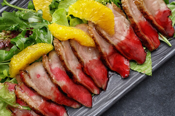 Sliced duck breast in caramel with oranges