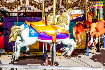 Fototapeta na wymiar White Merry Go Round Horse On Amusement Ride