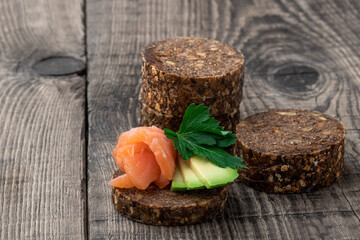 Wholegrain rye bread with seeds on a wooden table