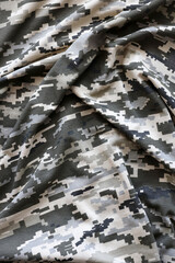 Fabric with texture of Ukrainian military pixeled camouflage. Cloth with camo pattern in grey,...