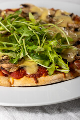 pizza on a plate with arugula