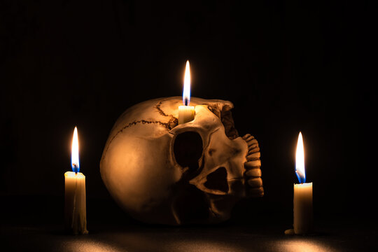 Skull on a black background with candles