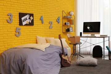 Stylish teenager's room interior with computer and bed
