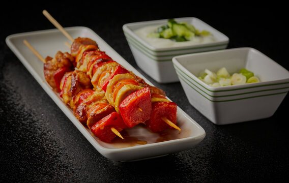 Greek kebabs with yogurt dip and spring onions.