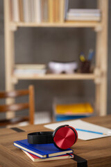 Music headphones and stack of notebooks at desk table. Study creative concept