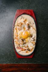 hot skillet with chicken and mushrooms in a creamy sauce