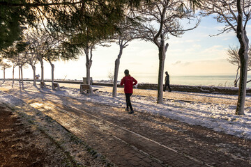 people walking in snowy morning. Beautiful panoramic view of winter landscape with many snow and frozen trees. Winter forest covered with snow. New Years landscape. Dramatic wintry scene.