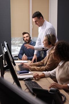 Call center operators working in modern office
