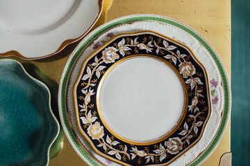 three stacks of vintage, unusual plates, dishes on gold