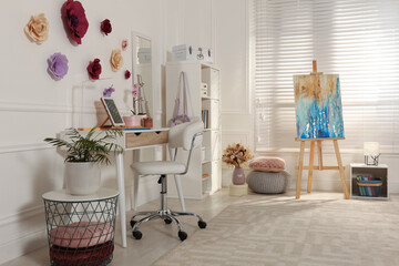 Stylish teenager's room interior with computer and painting easel