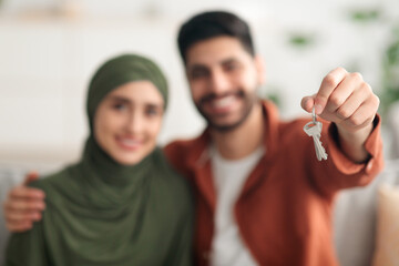 Young Middle Eastern Spouses Showing New House Key At Home