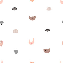 Seamless pattern with the muzzles of forest animals in the doodle style.
