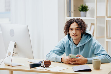 handsome guy sitting in front of the computer internet online interior