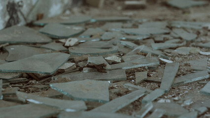 broken glass on the ground, in the dust, photos indoors