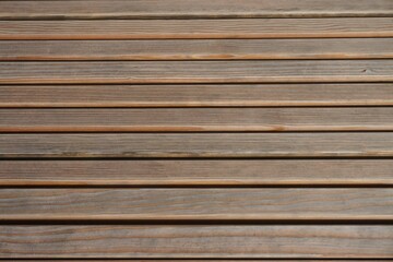 Gestreifte braune Lattenholzfläche bei Sonne am Abend im Frühling