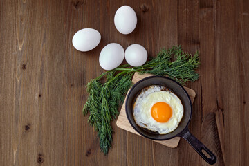 Fried chicken egg in a small frying pan with a stand