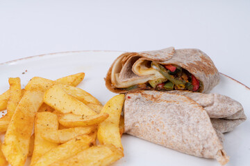 Close-up shot of spicy potatoes and meat chili wrap shot with selective focus from opposite angle on isolated white background.