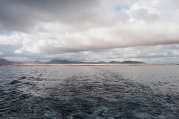 Sailing away from Fuerteventura ,Canary Islands, Spain. on a cloudy warm day 