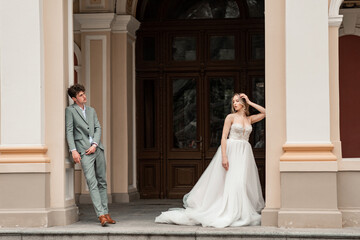 Beautiful bride and groom. Just merried. wedding couple.Close up. Happy bride and groom on their wedding hugging. Bride and groom at wedding near the old cathedral