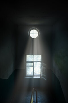 Old Room With A Beam Of Light Through A Round Window