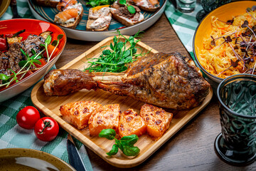 Roasted turkey leg with potatoes, carrots, onions and garlic