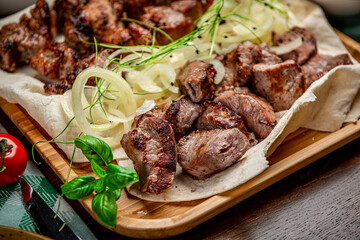 Delicious grilled pork shashlik on wooden table