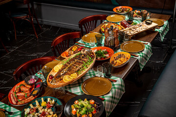 Restaurant table, many different dishes.