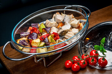 Stew with different types of fish and grilled vegetables.