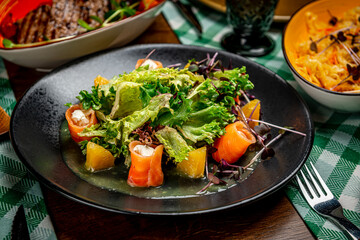 Salad with smoked salmon, cream cheese and orange sauce.