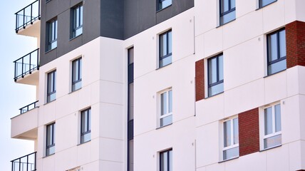 Modern european residential architecture on a sunny day. Exterior of new multi-story residential building. Concept of sale and rental of apartments for  consumers .Modern windows and balconies.