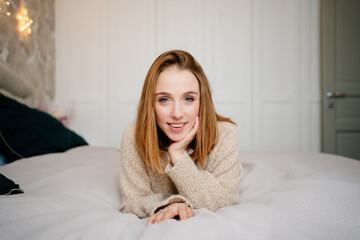 Naklejka premium an attractive young woman in a cozy sweater. natural beauty and cosmetics.