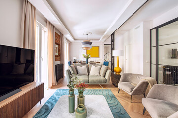 Living room with beautiful contemporary decoration with wooden furniture, vases, chairs and armchairs