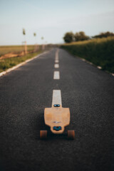 Longboard in the middle of the road without a figure. copy space.Vertical banner. Poster. Longboard day poster.