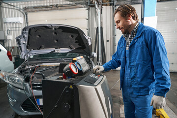 Man doing car maintenance in service center