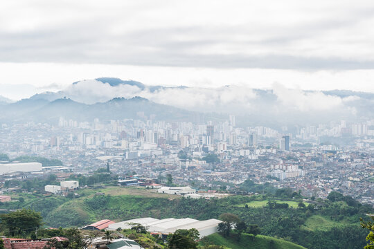 panoramic view of the city of Pereira-Colombia seen from the top of a mountain in the hours of the cold cloudy morning and with a lot of fog around.