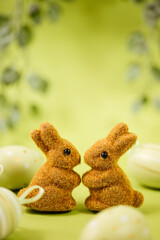easter bunny and eggs. Two brown Easter bunnies on a green background. Spring card and Easter card...