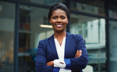 Im independent and successful. Portrait of an attractive young businesswoman posing with her arms folded outdoors in the city.