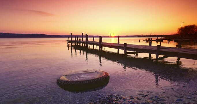 Sea sunrise ot sunset and wooden old jetty pier for fishermen. Travel and beautiful nature