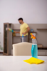 Young man doing housework at home