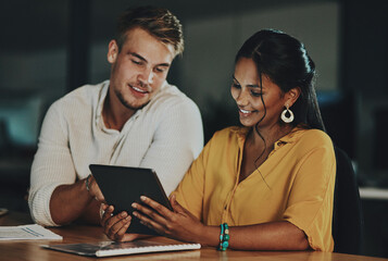 The world online will enable them to beat the deadline. Shot of two businesspeople using a digital...
