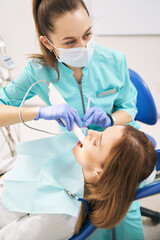 Female doctor examining woman teeth with dental 3D scanner - obrazy, fototapety, plakaty