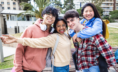 Cheerful multiracial group of young students friends smiling at camera while standing outdoors at campus university - Education and millennial people concept