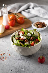 Salad with herbs and fruits on a light background