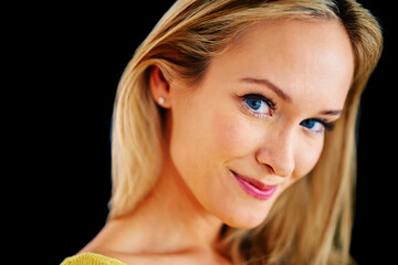 Stunningly beautiful. Closeup studio portrait of a beautiful young blonde woman on a black background.