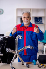 Old male repairman repairing office chair