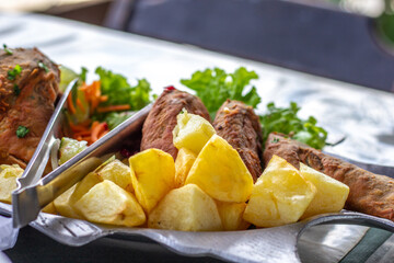 fried fish dish with browned potatoes and shrimp pirão (brazilian sauce)