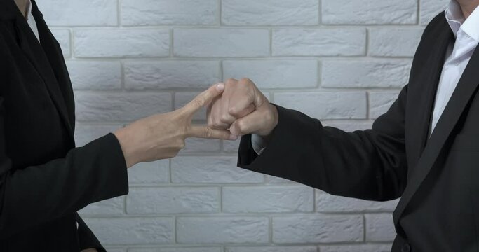 Rock paper scissors in business. A man and a woman make a choice with rock paper scissors game in the office.