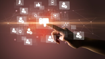 Hand pressing social media multimedia application screen with media icons on futuristic concept